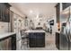 Open concept kitchen with a center island flows into a living area with a fireplace and entertainment center at 4938 Via Luis Ct, North Las Vegas, NV 89031