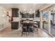 Charming kitchen island with bar stool seating and stainless appliances at 4938 Via Luis Ct, North Las Vegas, NV 89031