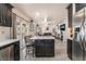 Open-concept kitchen with an island flows into the living area with a fireplace at 4938 Via Luis Ct, North Las Vegas, NV 89031