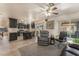 Comfortable living room featuring plush seating, a ceiling fan, and access to the backyard at 4938 Via Luis Ct, North Las Vegas, NV 89031