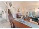 Bright living room with high ceilings, an adjacent staircase, and comfortable seating at 4938 Via Luis Ct, North Las Vegas, NV 89031