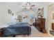 Comfortable main bedroom with a ceiling fan, carpet flooring, and natural light at 4938 Via Luis Ct, North Las Vegas, NV 89031