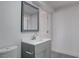 Updated bathroom with a modern vanity, a sleek mirror, and a toilet with gray floors at 501 National St, Henderson, NV 89015