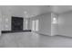 Spacious living room features a striking stone fireplace and ample natural light from large windows and french doors at 501 National St, Henderson, NV 89015