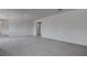 Spacious living room with gray wood flooring, neutral walls, and access to hallways at 501 National St, Henderson, NV 89015
