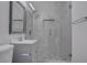 Renovated bathroom features a tiled shower with glass door, stone floor and a modern vanity at 501 National St, Henderson, NV 89015