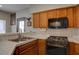 Bright kitchen featuring a stainless steel stove and dual basin sink at 5225 W Reno Ave # 137, Las Vegas, NV 89118