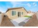 Wide view of the home's backyard with a concrete patio, rock landscaping, and fenced perimeter at 5648 Alitak Bay St, North Las Vegas, NV 89081