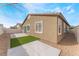 Side view of a fenced backyard with concrete patio and rock landscaping with artificial turf at 5648 Alitak Bay St, North Las Vegas, NV 89081