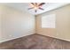 Bedroom featuring ceiling fan, carpet and a window providing natural light at 5648 Alitak Bay St, North Las Vegas, NV 89081