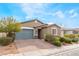 Charming single-story home with a two-car garage, a cozy porch, and well-maintained landscaping at 5648 Alitak Bay St, North Las Vegas, NV 89081