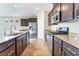 Well-equipped kitchen features granite counters, stainless steel appliances and tile flooring at 5648 Alitak Bay St, North Las Vegas, NV 89081