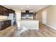 Open kitchen featuring granite countertops, large island, and dark wood cabinets at 5648 Alitak Bay St, North Las Vegas, NV 89081