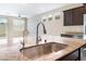 Close-up of granite countertop island featuring stainless steel sink and fixtures at 5648 Alitak Bay St, North Las Vegas, NV 89081
