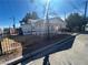 Exterior view showcasing the single-story home, fenced yard and neighborhood surroundings at 5903 Whitney Ave, Las Vegas, NV 89122