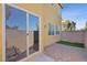 Backyard featuring a sliding glass door, paver patio and block wall providing privacy and outdoor living space at 6121 Sinatra Sands Ct, Las Vegas, NV 89130