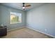 A bedroom with gray walls, carpet, and a ceiling fan at 6121 Sinatra Sands Ct, Las Vegas, NV 89130
