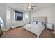 Bright bedroom features a ceiling fan, large windows and a comfortable bed at 6121 Sinatra Sands Ct, Las Vegas, NV 89130