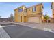 Two-story home featuring a tile roof, two-car garage, neutral paint scheme, and well-maintained landscaping at 6121 Sinatra Sands Ct, Las Vegas, NV 89130