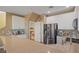 Stylish kitchen featuring white cabinets, modern stainless steel appliances, and stone countertops at 6121 Sinatra Sands Ct, Las Vegas, NV 89130