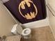 Bathroom with toilet adjacent to tub with Batman shower curtain at 7200 Pirates Cove Rd # 1025, Las Vegas, NV 89145