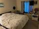 Relaxing bedroom with comfortable bed, accent chair, and natural light from the window at 7200 Pirates Cove Rd # 1025, Las Vegas, NV 89145