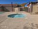 Community hot tub with clear blue water and secure fencing around the perimeter for safety at 7200 Pirates Cove Rd # 1025, Las Vegas, NV 89145