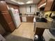 Functional kitchen featuring tile flooring, wooden cabinets, and essential appliances at 7200 Pirates Cove Rd # 1025, Las Vegas, NV 89145
