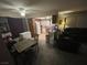 Cozy living area featuring neutral carpet, table, and a comfortable black sofa at 7200 Pirates Cove Rd # 1025, Las Vegas, NV 89145