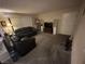 Spacious living room with neutral carpet, black sofa and media center at 7200 Pirates Cove Rd # 1025, Las Vegas, NV 89145
