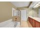 Bathroom featuring a dual sink vanity, soaking tub and separate shower stall at 820 Canterra St # 1054, Las Vegas, NV 89138