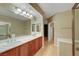 Bright bathroom featuring dual sink vanity, large mirror and walk-in shower at 820 Canterra St # 1054, Las Vegas, NV 89138