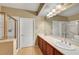 Bright bathroom with dual sinks, large mirror and walk-in shower at 820 Canterra St # 1054, Las Vegas, NV 89138