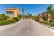 Community entrance with brick road, desert landscaping, and a privacy gate at 820 Canterra St # 1054, Las Vegas, NV 89138