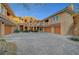 Attractive townhouses featuring two-story units, attached garages, and lovely desert landscaping at 820 Canterra St # 1054, Las Vegas, NV 89138