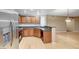 Open kitchen with stainless steel refrigerator, wooden cabinetry, and adjacent dining area at 820 Canterra St # 1054, Las Vegas, NV 89138