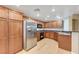 Bright kitchen with stainless steel refrigerator, gas range, and wood cabinetry at 820 Canterra St # 1054, Las Vegas, NV 89138