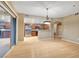 Bright living room with wood floors, sliding glass doors, and a view of the kitchen at 820 Canterra St # 1054, Las Vegas, NV 89138