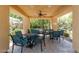 Community patio with tables, chairs, ceiling fan and a view of the lush landscaping at 820 Canterra St # 1054, Las Vegas, NV 89138