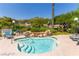 Inviting community spa pool with waterfall feature, lounge chairs, and lush landscaping at 820 Canterra St # 1054, Las Vegas, NV 89138