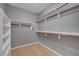 Walk-in closet with built-in shelving and rods for organized storage at 820 Canterra St # 1054, Las Vegas, NV 89138