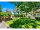 Lush backyard featuring a large grassy area and mature landscaping, ideal for outdoor enjoyment at 8211 Windsor Crest Ct, Las Vegas, NV 89123