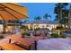 Stunning outdoor entertaining area with a custom rock waterfall, pool, spa, and dining area at 8211 Windsor Crest Ct, Las Vegas, NV 89123