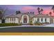 Stunning home featuring lush landscaping, a tile roof, and a custom metal entry gate at 8211 Windsor Crest Ct, Las Vegas, NV 89123