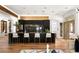 Modern kitchen island with black cabinets, marble counters, and seating for four at 8211 Windsor Crest Ct, Las Vegas, NV 89123