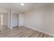 Bedroom with wood-look flooring, closet with bi-fold doors, and neutral paint at 8212 Fawn Brook Ct, Las Vegas, NV 89149