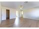 Bedroom with neutral paint, laminate floors, ceiling fan, and two entryways at 8217 Maplestar Rd, Las Vegas, NV 89128