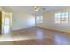 Spacious bedroom with light colored laminate wood flooring, ceiling fan, and natural light at 8217 Maplestar Rd, Las Vegas, NV 89128