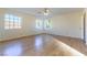 Bright bedroom with laminate floors, ceiling fan, and two windows allowing ample natural light at 8217 Maplestar Rd, Las Vegas, NV 89128