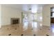 Cozy living room with a fireplace and sliding glass doors leading to the backyard pool area at 8217 Maplestar Rd, Las Vegas, NV 89128